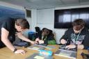 Skills - Harwich Haven Authority IT Support Engineer, Sean Brattan (left) working with Jake and Ellis to rebuild a laptop