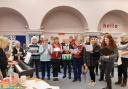 Carols - Members of Grace Notes singing at Manningtree Library, with Susie on the left at the piano.