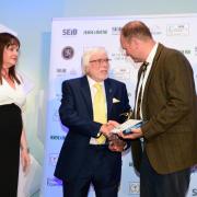 Award - Trevor Hunnaball receives the lifetime achievement award from Andrew Judd, chief executive of  the NAFD, and Suzy Middleton, of sponsors SEIB