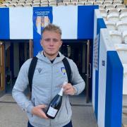 Colchester's Joe Taylor with his man of the match award. Image: Neil Kelly