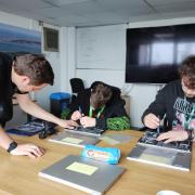 Skills - Harwich Haven Authority IT Support Engineer, Sean Brattan (left) working with Jake and Ellis to rebuild a laptop