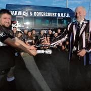 ON THE RIGHT ROAD: Harwich and Dovercourt Rugby Club skipper Kyle Hutchins, chairman Barry Male and the club’s first team squad celebrate gaining a new mini-bus courtesy of club sponsor Chassis-Cab. Picture: John Holland