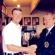 GOLDEN GLORY: Jordan Slater being presented with the club championship gold division silverware by club captain Gus Hales.