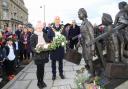 Laying flowers: Amelia Steele, 10, and mayor Ivan Henderson lay flowers on Holocaust Memorial Day at Harwich’s Kindertransport Memorial at The Quay. Picture: Maria Fowler