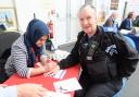 Community - A police officer getting a temporary tattoo at the event