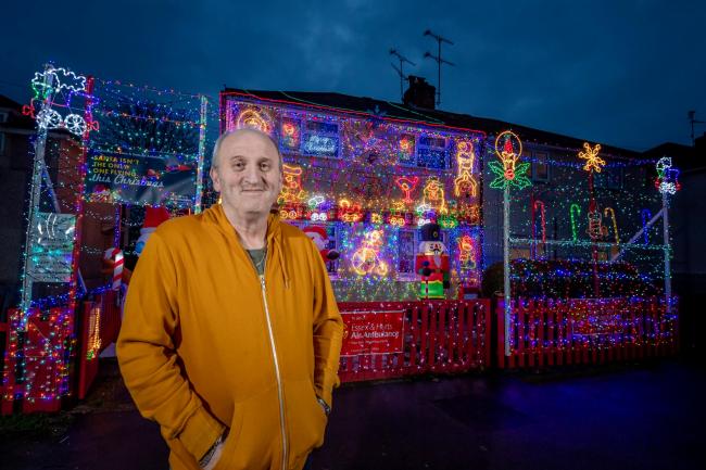 Carer Paul spent three weeks in November stringing up 'around 30,000' bulbs on the front and sides of his semi-detached home. Picture: SWNS