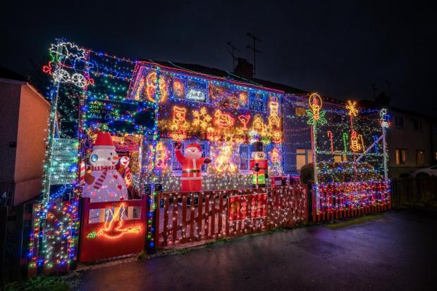 Harwich and Manningtree Standard: The display also features several festive inflatable decorations including a giant Santa and a snowman, which Paul says are popular with kids in the area. Picture: SWNS 