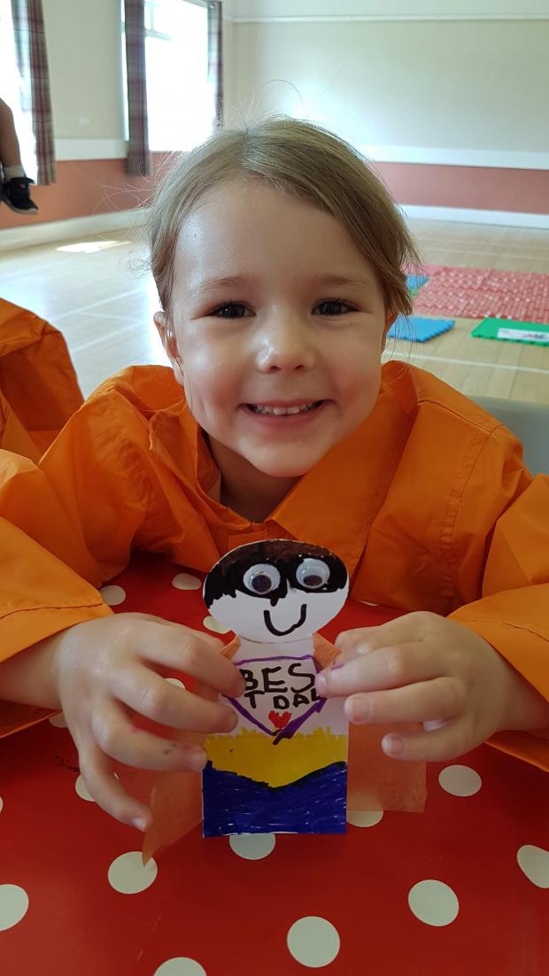 Harwich and Manningtree Standard: All smiles - Annabelle Lee, five, holding her superhero flying father's day card