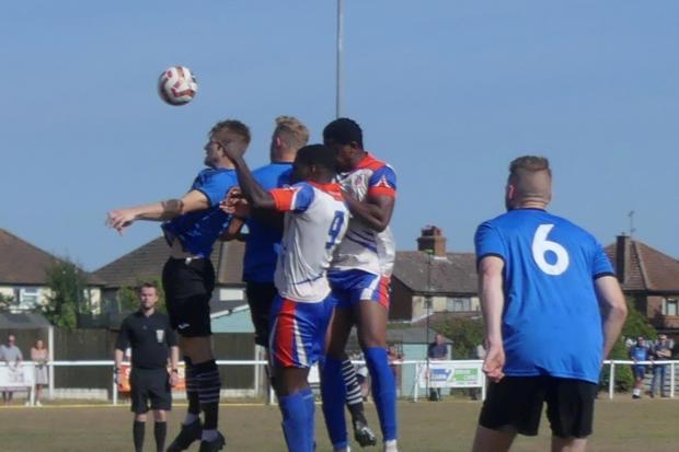 High rise: Little Oakley (blue shirts) challenge for a high ball against FC Clacton Picture: ANDY BLOOM