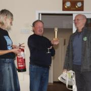 Big award: Mike Wilson presented the trophy to Jon and Pam Fitzgerald at the Festival Friends’ Reception at Harwich Town Sailing Club on October 7. Picture: Paul Turvey