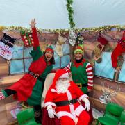 Festive - Santa in his grotto with his elves.