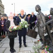 Laying flowers: Amelia Steele, 10, and mayor Ivan Henderson lay flowers on Holocaust Memorial Day at Harwich’s Kindertransport Memorial at The Quay. Picture: Maria Fowler