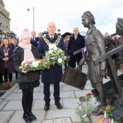 Laying flowers: Amelia Steele, 10, and mayor Ivan Henderson at Harwich’s Kindertransport Memorial at The Quay. Picture: Maria Fowler