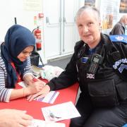 Community - A police officer getting a temporary tattoo at the event