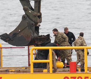 the remains of a ww2 V2 rocket is recovered from Harwich harbour on Saturday
on the deck